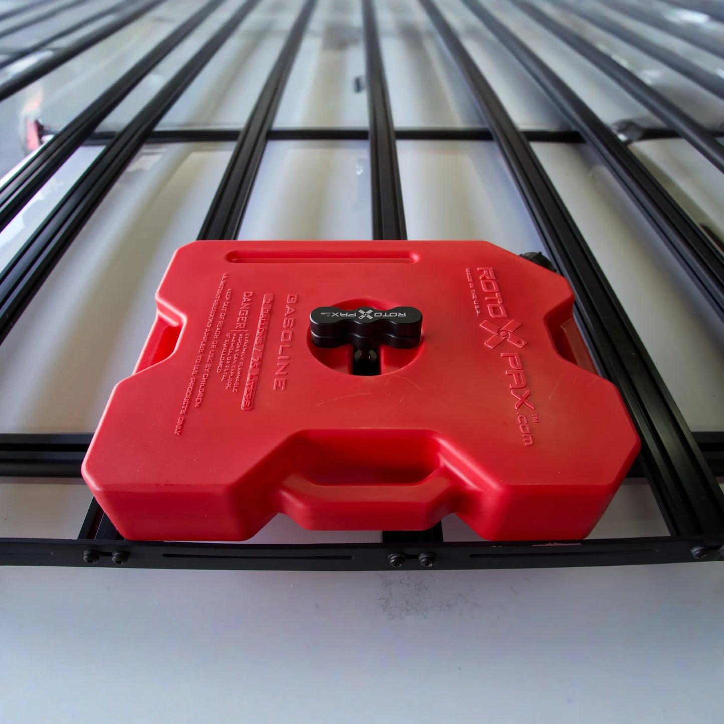 Billet aluminum Rotopax mount adapter for extrusion roof rack cross bars.