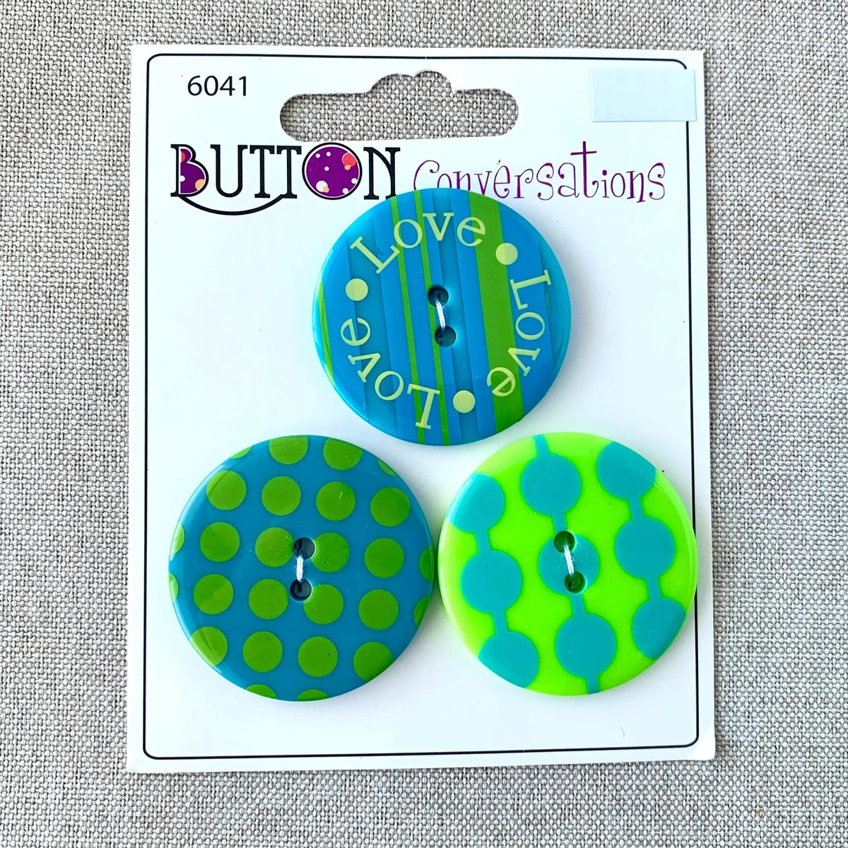 Love Love Love 6041 - Button Conversations - 2 Hole - Blue Green - 🆕 New Arrivals, All Products, Products from The Attic Exchange, 🎨 Arts + Entertainment, 🎨 Hobbies + Creative Arts - Little Red General Store